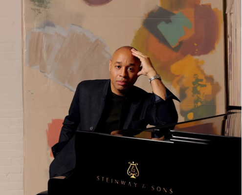 AaronDiehl Aaron Diehl sitting at piano